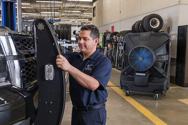 Automotive tech works happily in a cooler shop.