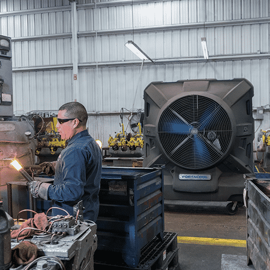 Man working with red-hot iron in a safer place because of the cooling zone.