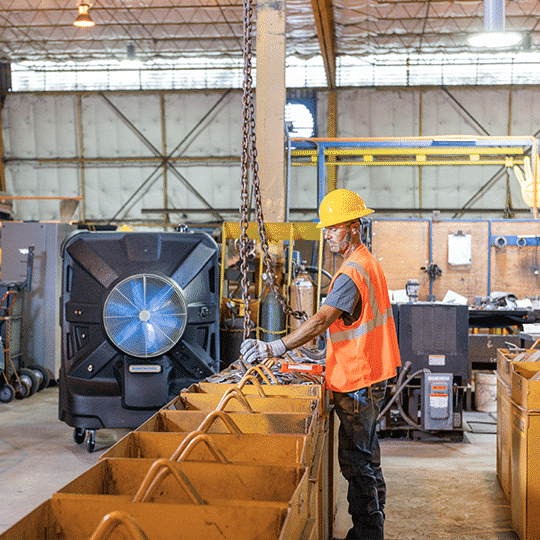 Man in personal safety gear works in a less hazardous environment as the temperature was lowered by evaporative cooling.