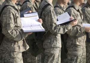 troops reading from manuals during military training