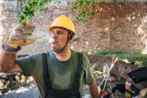 construction worker hydrating in the heat