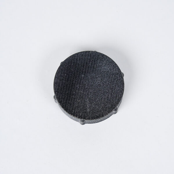 APEX™ Drain Cap and Gasket Kit, round, black with edge protrusions, on white background.