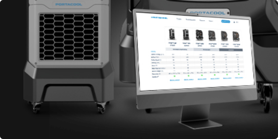 A monitor displays a comparison chart of evaporative coolers, with parts of two units nearby. One unit has a hexagonal front grille.