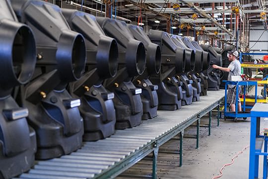 Unit housings lined up on a conveyor belt showing efficiency and durability.